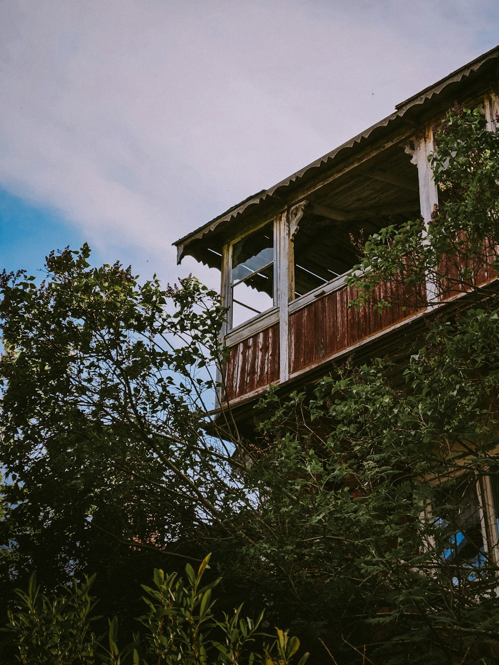 a tall wooden building with a balcony and a balcony