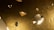 Numerous floating or levitating diamonds, cut in various shapes, with a glimmering, reflective quality. The background has a textured, gold-hued appearance.