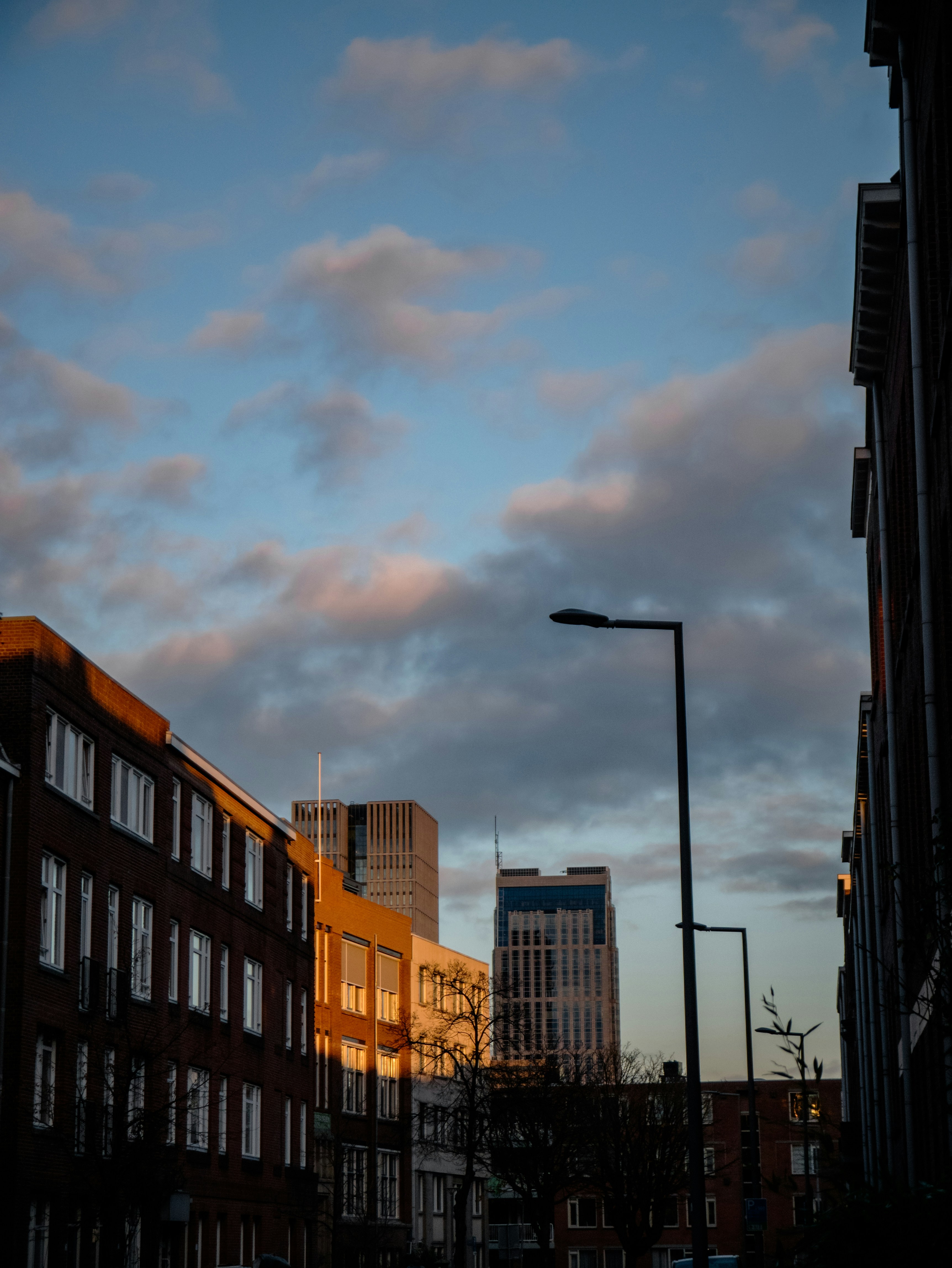 a city street with buildings and a street light
