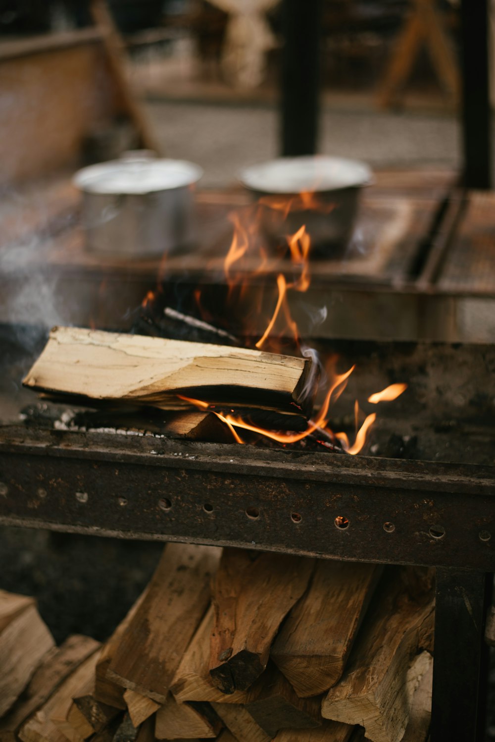 a grill with a bunch of wood on top of it