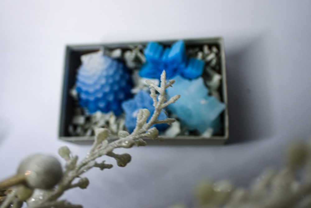 a box of blue and white ornaments sitting on a table