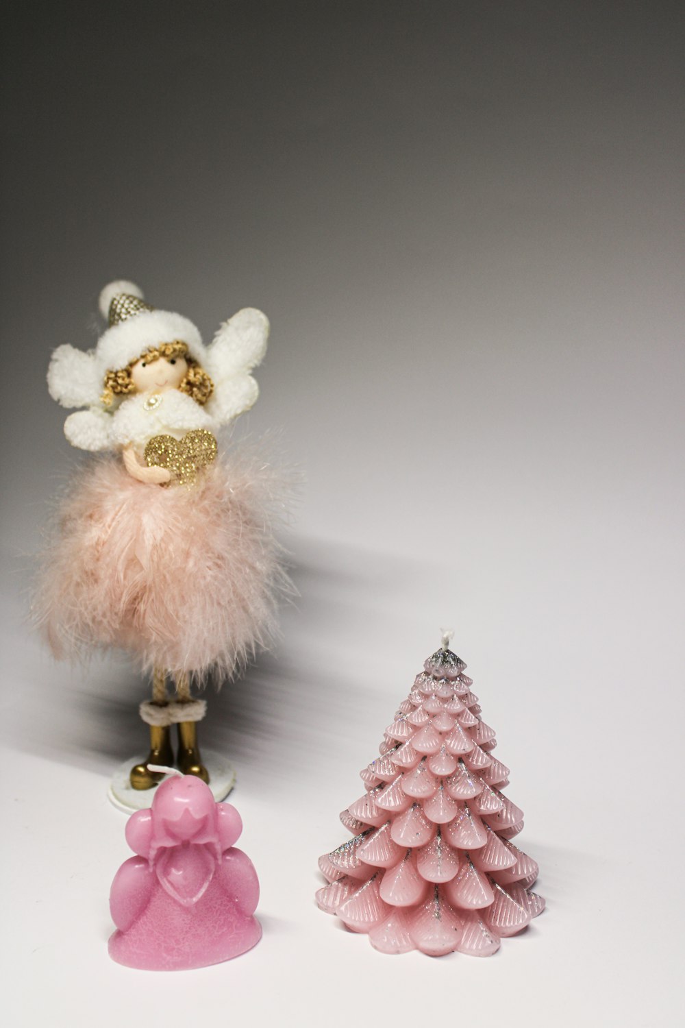 a small christmas tree and a small angel figurine