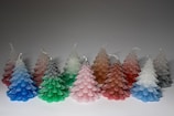 A collection of uniquely shaped candles in various seasonal themes.
