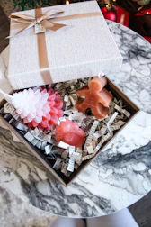Close-up of premium gift items inside a festive box, showcasing quality and care.