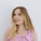 a woman in a pink dress posing for a picture