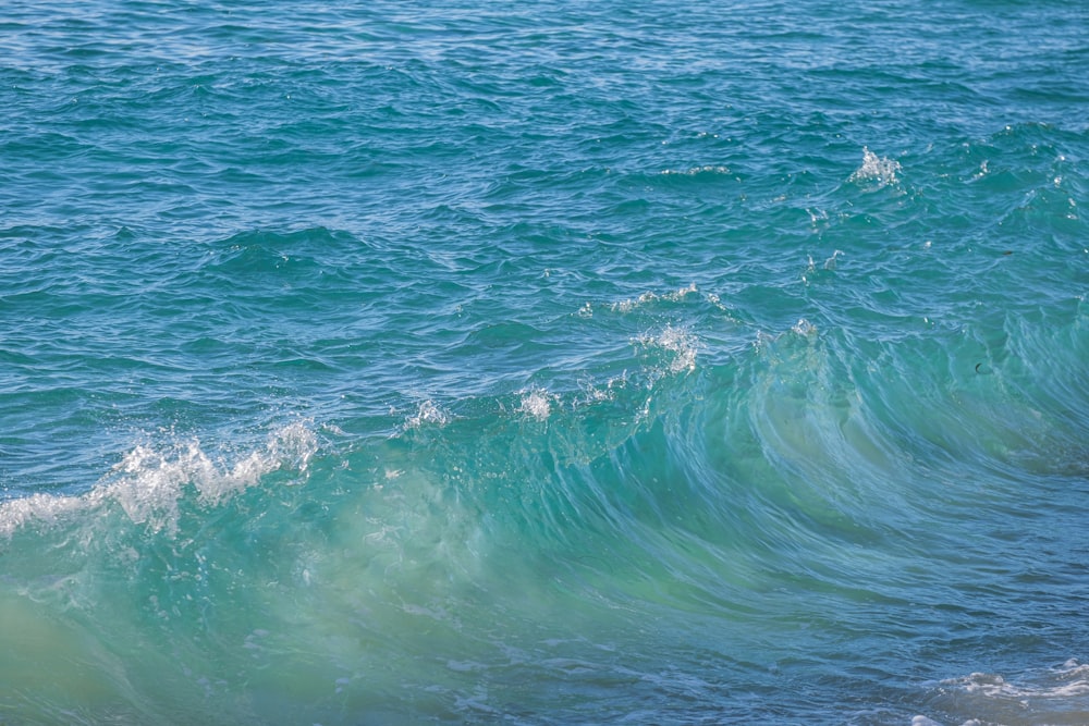 a man riding a surfboard on top of a wave in the ocean