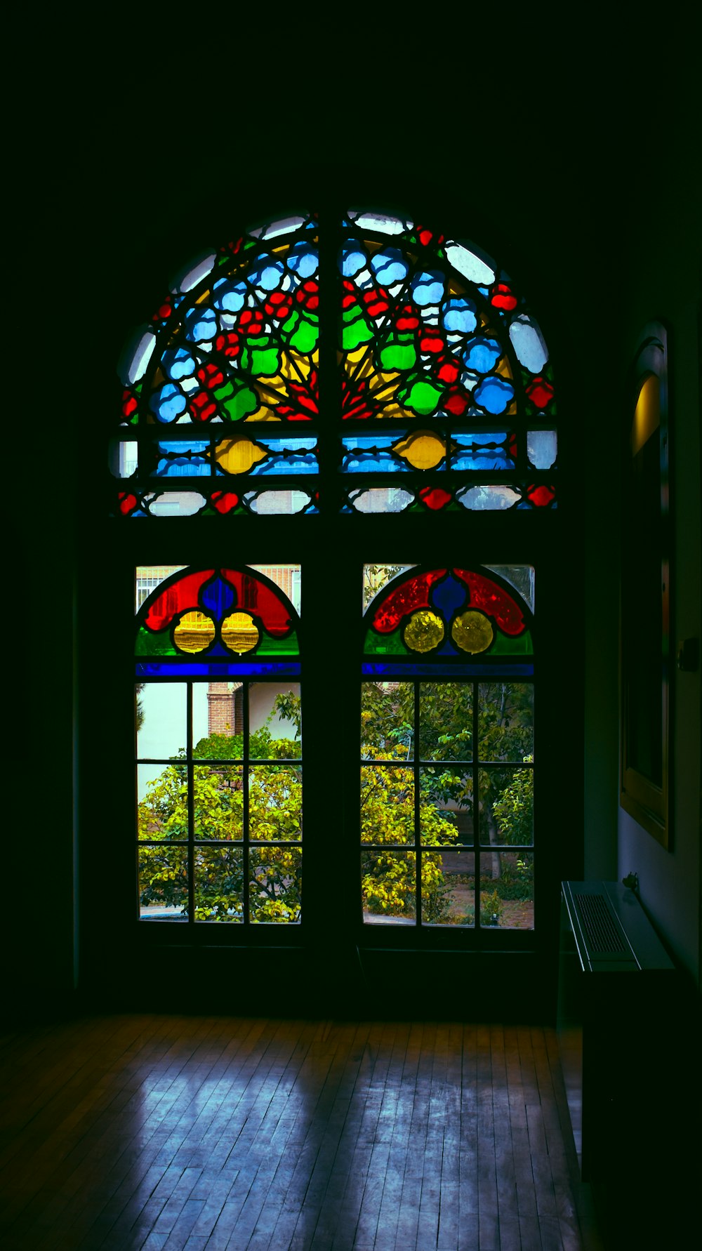 a large stained glass window in a dark room