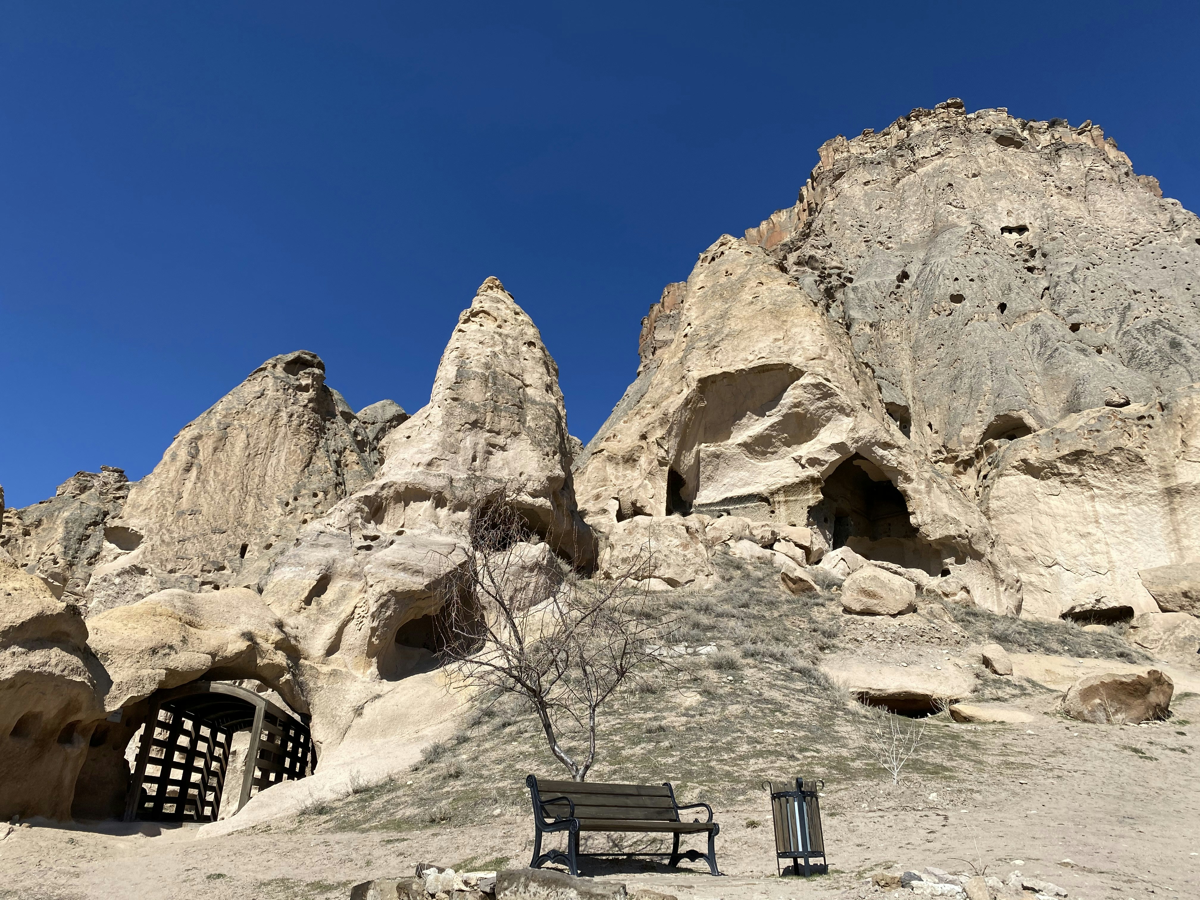 a bench sitting in front of a rock formation