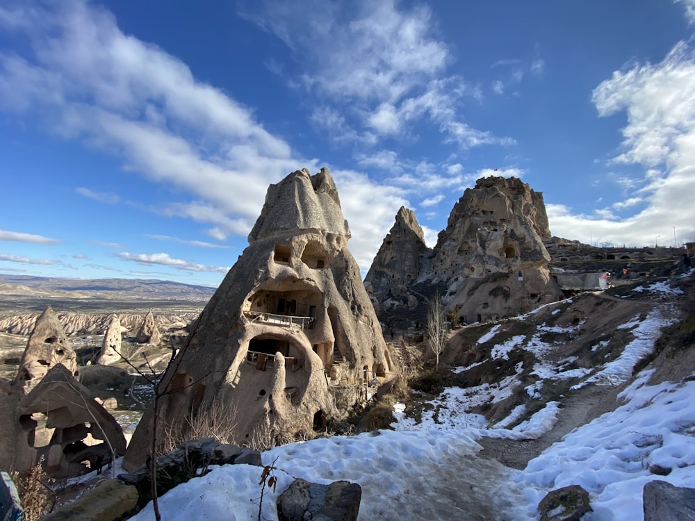 a group of rock formations in the snow