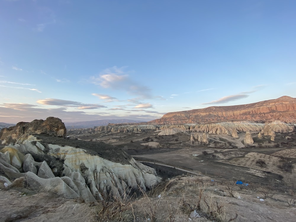 a view of a rocky landscape with mountains in the background