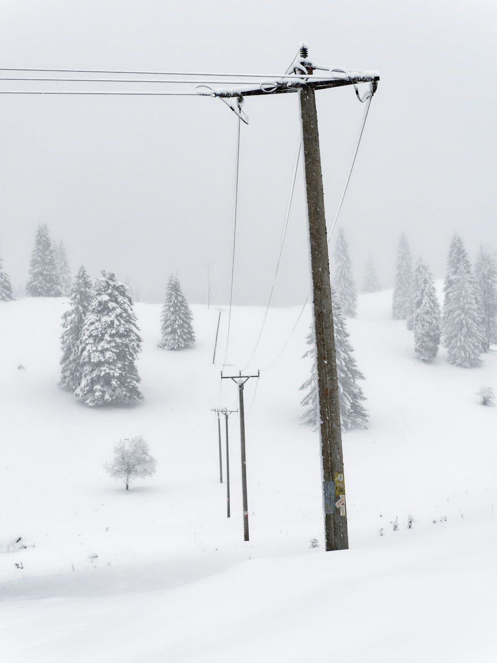 a ski lift in the middle of a snowy landscape