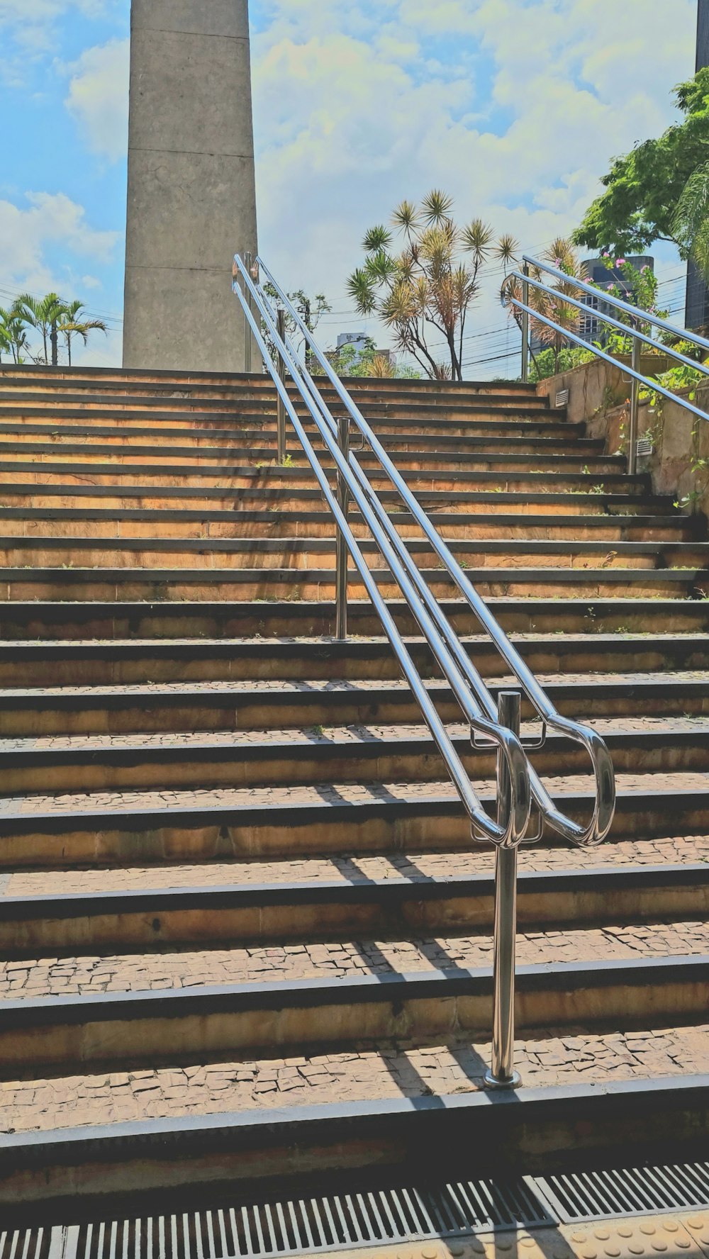a stair case with a metal hand rail on top of it