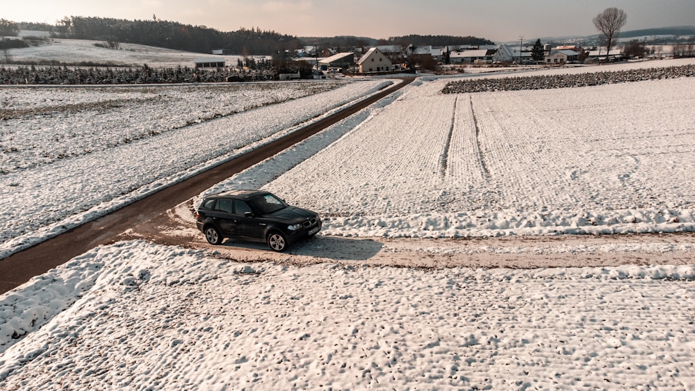 a car driving down a snow covered road