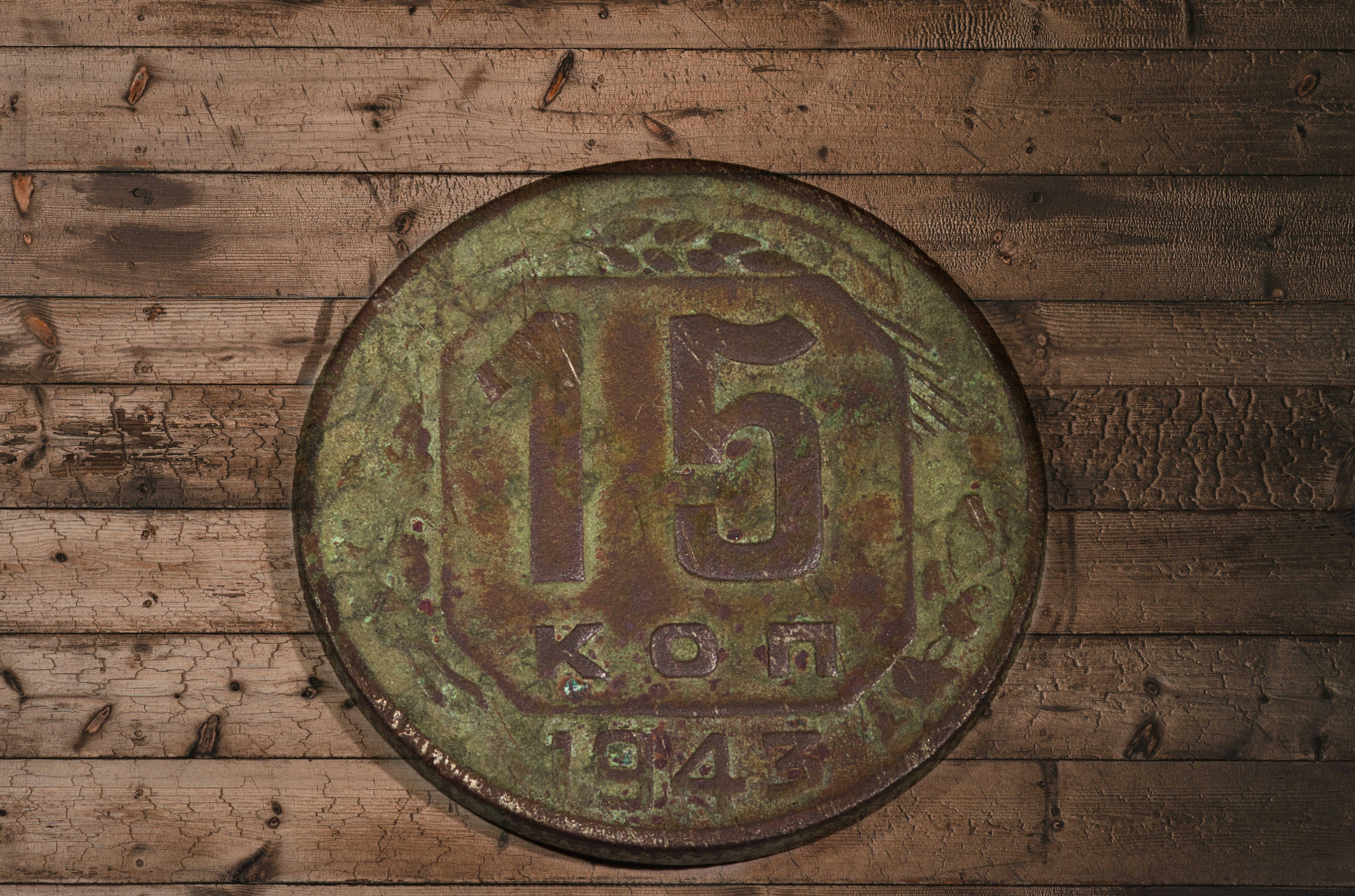 a rusty metal plate on a wooden wall