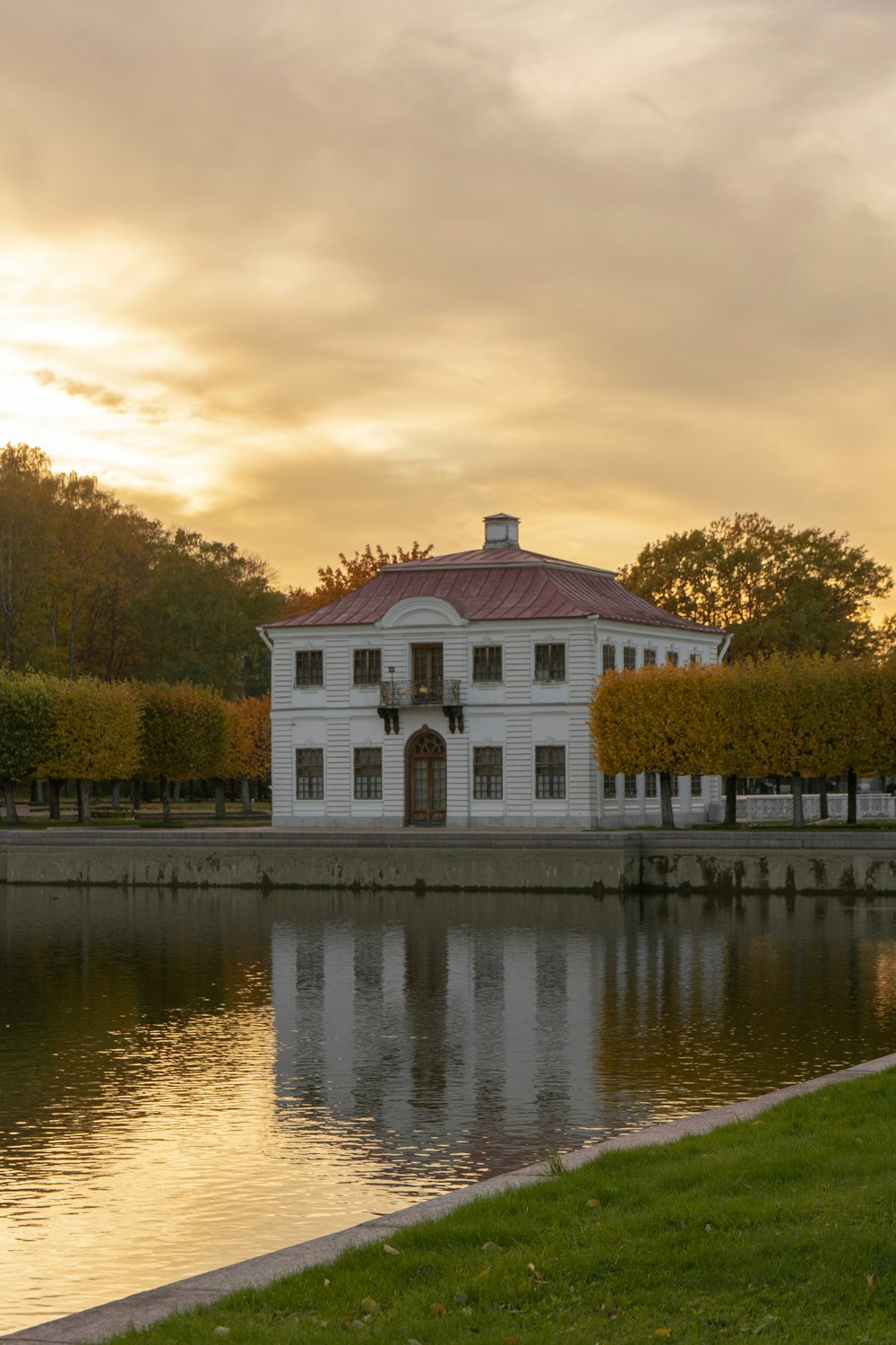 a large white building sitting next to a body of water