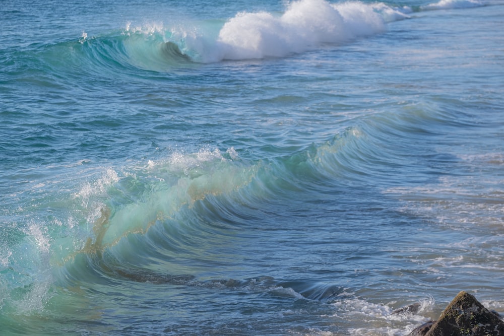 a person riding a surfboard on a wave in the ocean