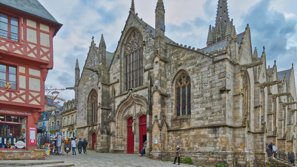 a large stone building with a red door