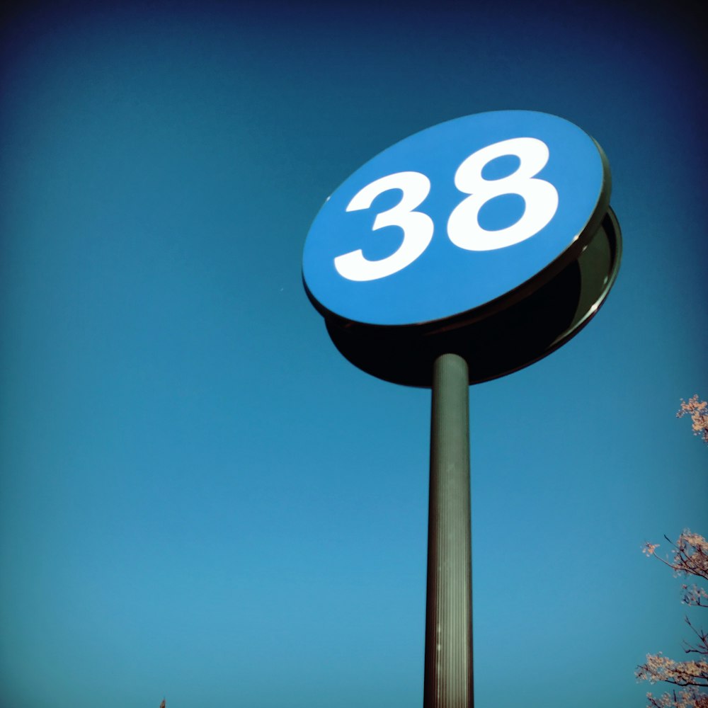 a blue and white sign with the number 38 on it