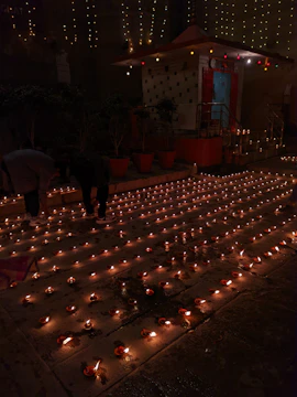 Volunteers arranging flowers and lamps for the Mahashivratri festival preparations