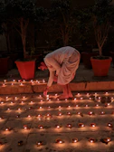 Devotees lighting traditional oil lamps during a serene evening prayer.