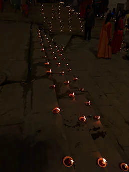 A serene community gathering with diverse South Asian families sharing stories under warm, golden light.