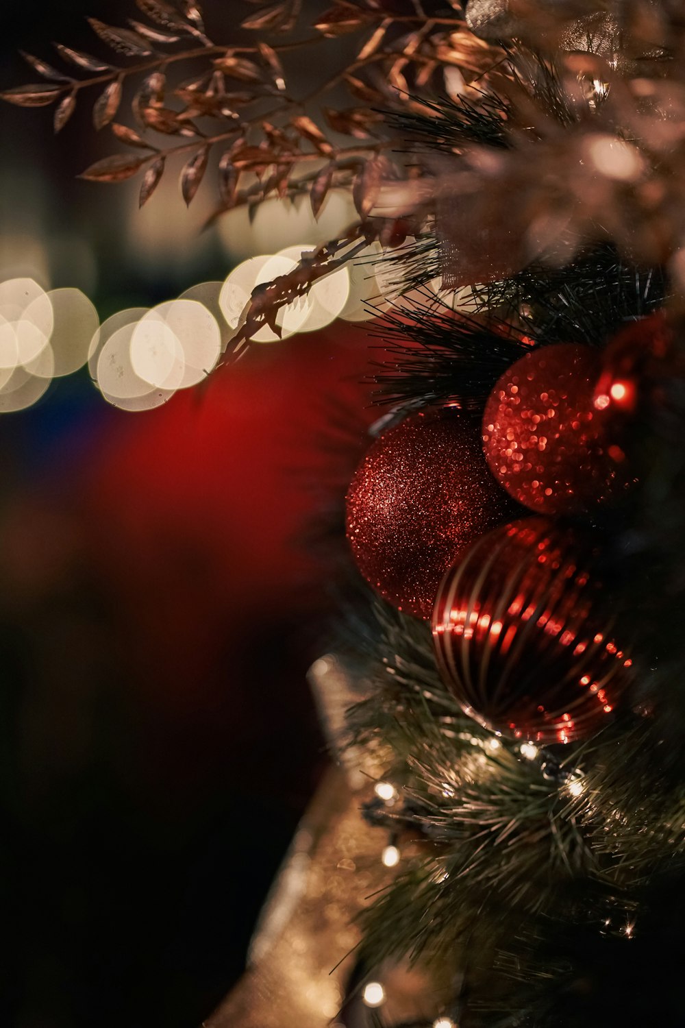 a close up of a christmas tree with lights in the background