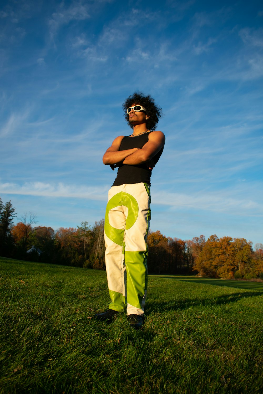 a man standing on top of a lush green field