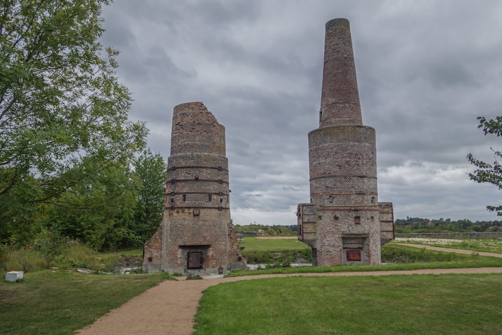 a couple of brick structures sitting in the middle of a field