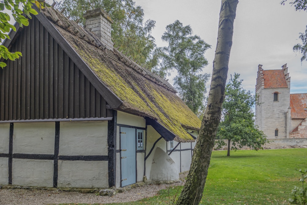 a white and black house with a green roof