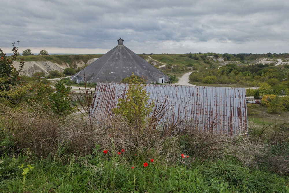 a barn with a metal roof in a field