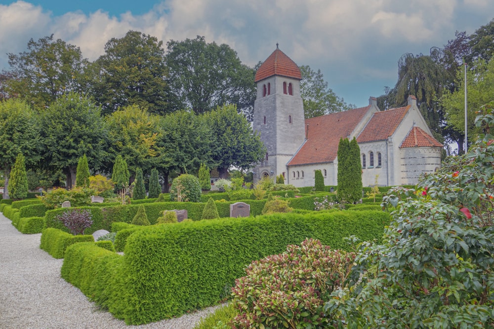 a church surrounded by hedges and trees