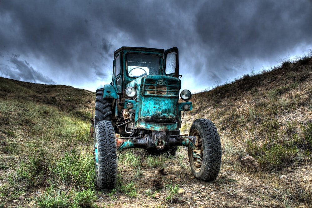 an old truck sitting in the middle of a field