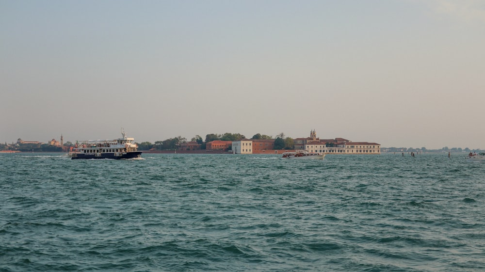a large body of water with houses in the background