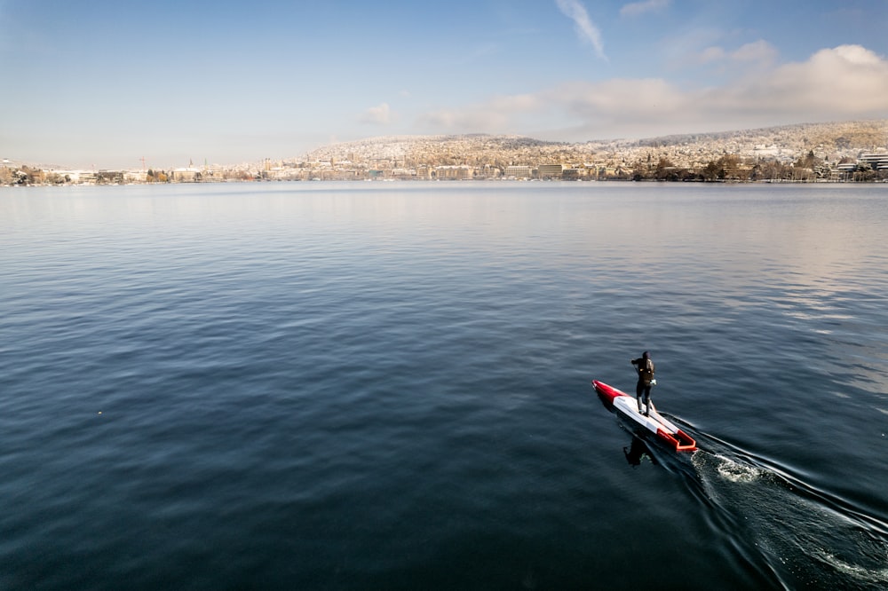 a man rowing a boat on a large body of water