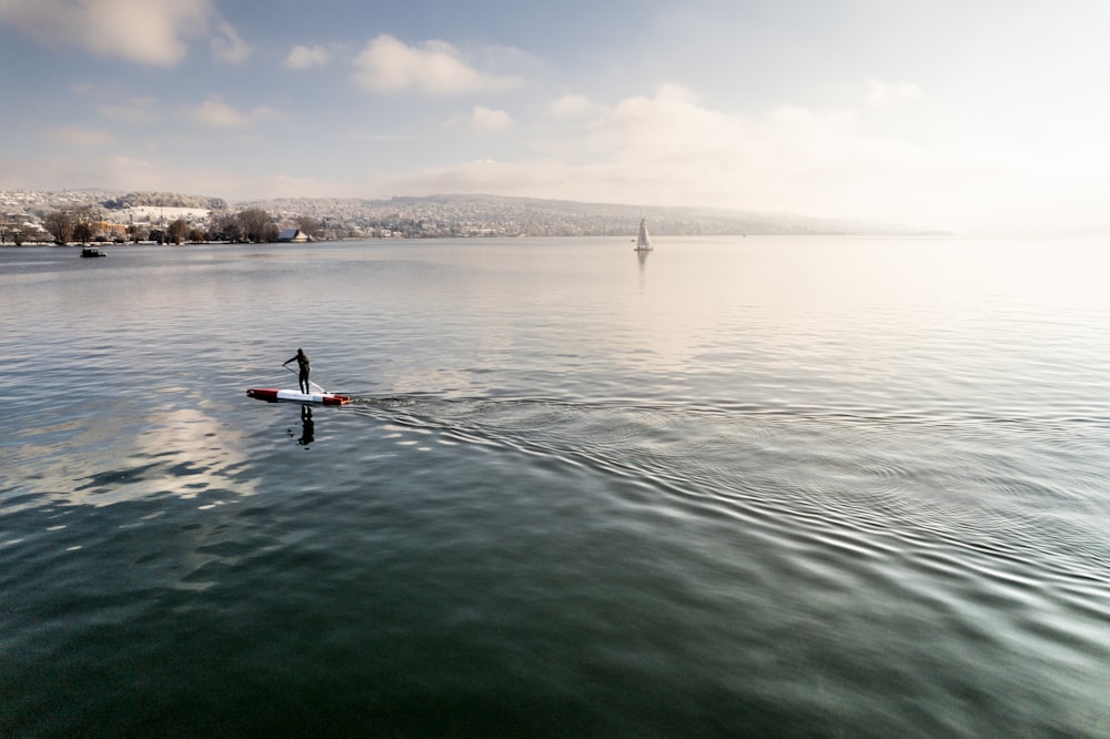 a person on a paddle board in the water