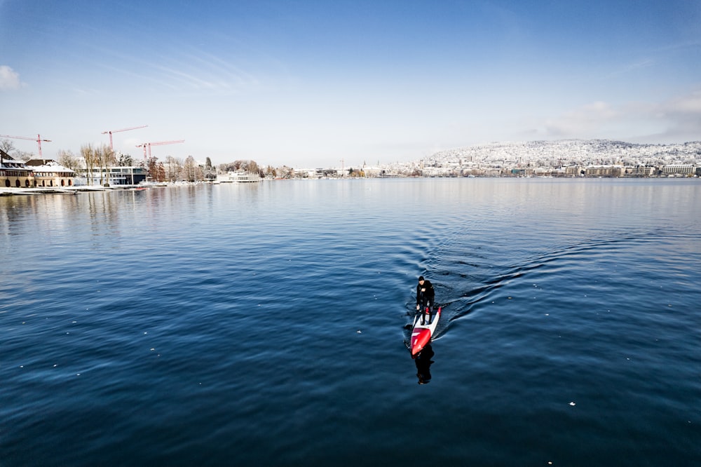 une personne sur une planche de surf au milieu d’un plan d’eau