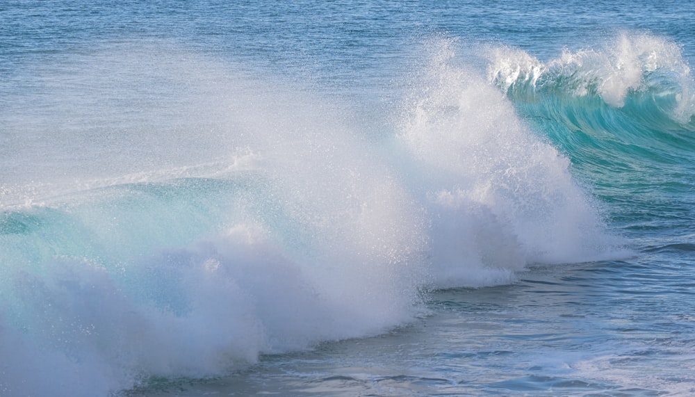 a man riding a wave on top of a surfboard