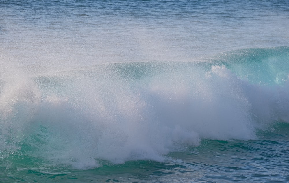 a man riding a wave on top of a surfboard