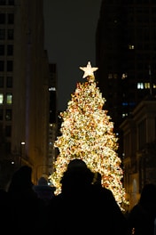 a large christmas tree in the middle of a city