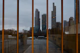 Close-up detail of modern glass panels reflecting a vibrant city skyline.