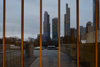 Close-up detail of modern glass panels reflecting a vibrant city skyline.