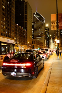 Nighttime city skyline of Newark with a NJ Sprinters van ready for an airport transfer.