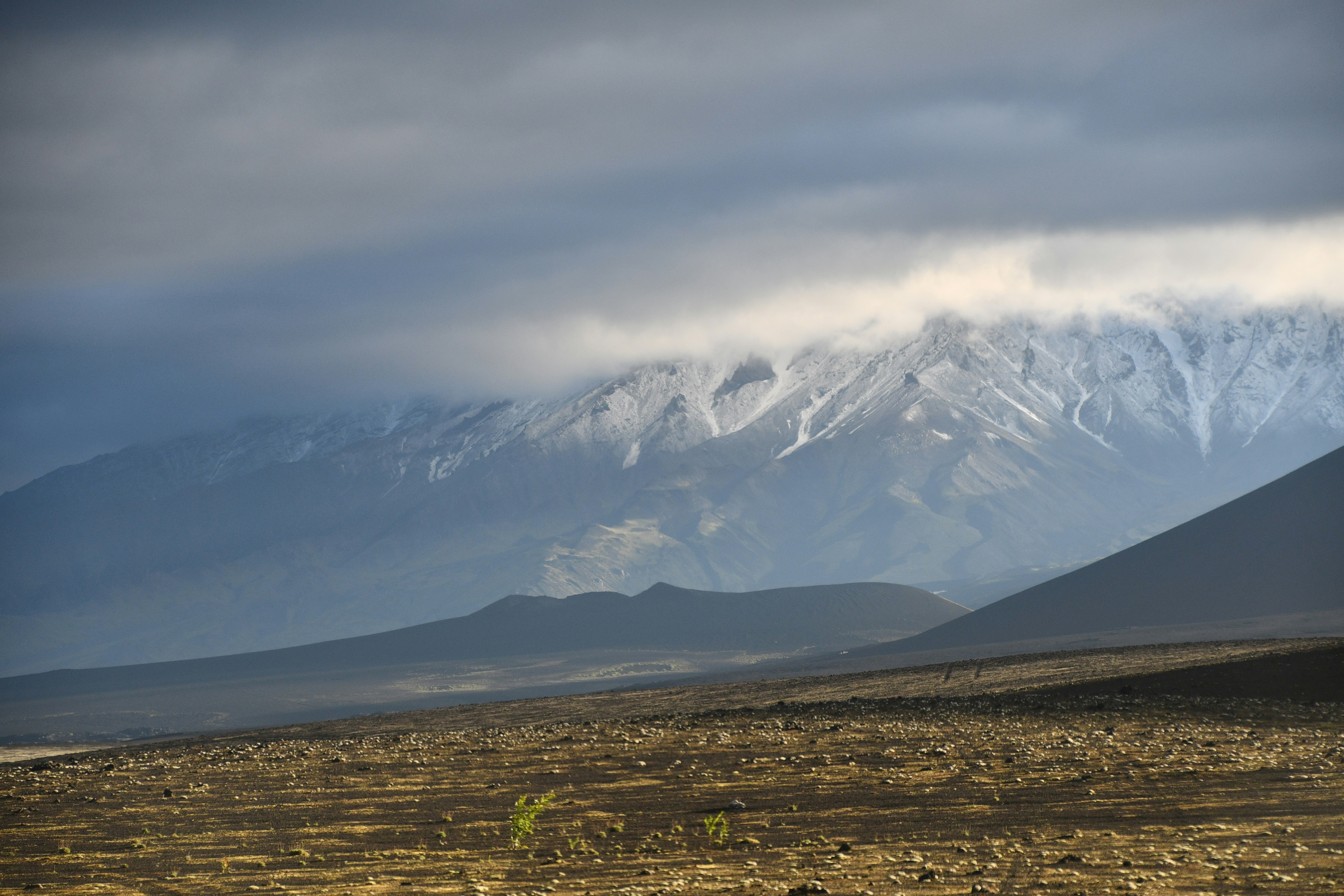 a snow covered mountain range in the distance