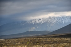 a snow covered mountain range in the distance