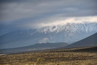 a snow covered mountain range in the distance