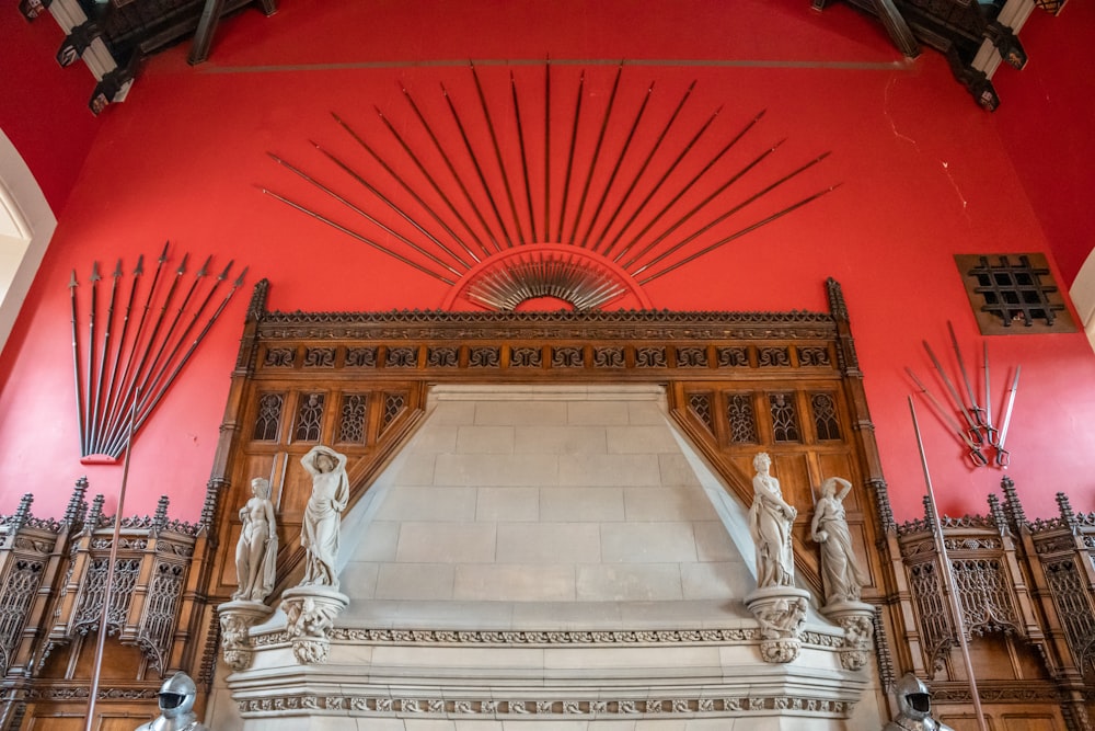 a red and white building with sculptures on the wall