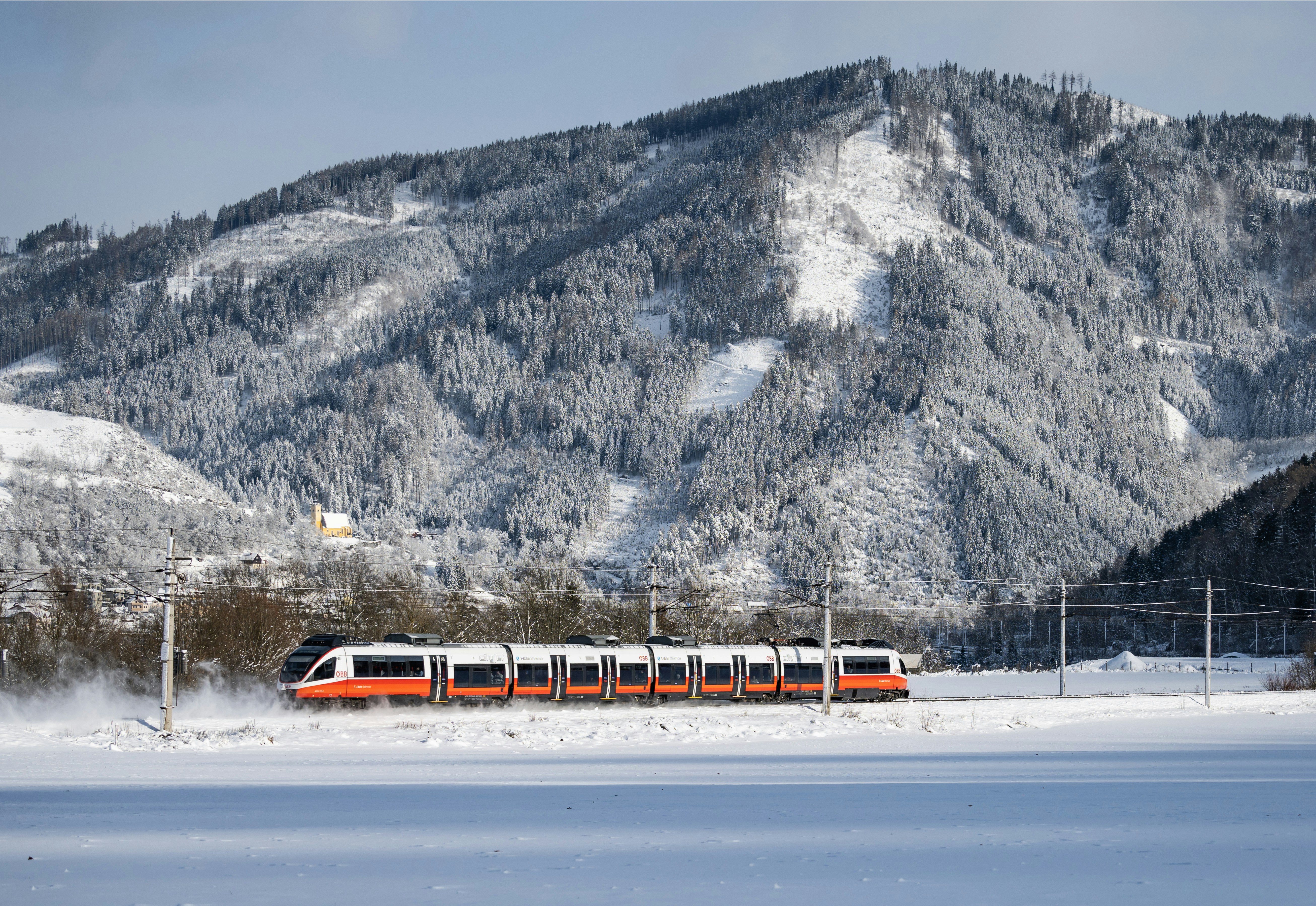 a train traveling through a snow covered countryside