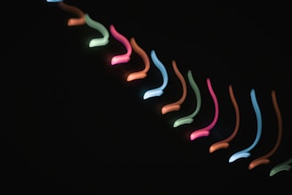 An animated sequence showing glowing lines tracing intricate patterns against a dark background.
