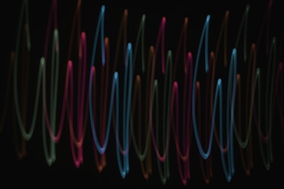 Abstract AI-generated music visuals with pulsating curves and dynamic light effects.