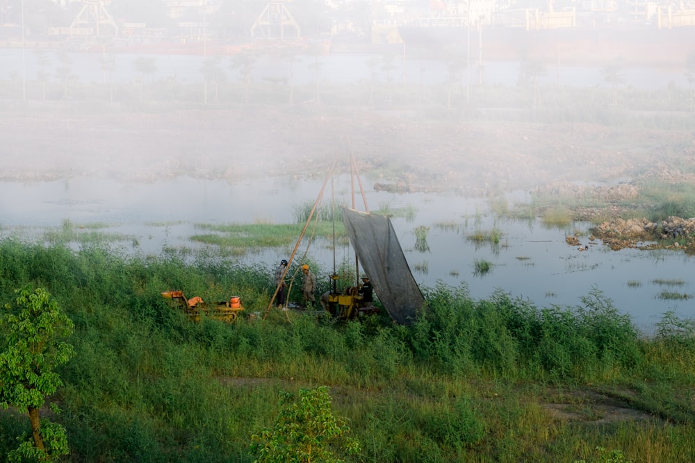 a boat sitting on top of a lush green field